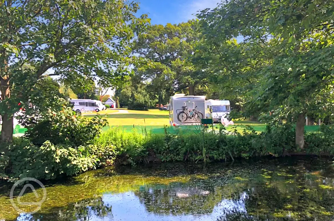 Grass pitches by the pond