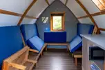 Camping pod interior with benches/sleeping platforms