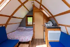 Glamping pods with a double bed, bench seating and an ensuite toilet