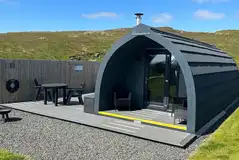 Castle glamping pods with a large outdoor deck and hot tub