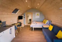 Accessible Castle pod with a double bed, kitchen, sofa and ensuite