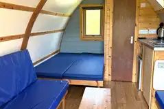 Glamping pods with a double bed, bench seating and an ensuite toilet