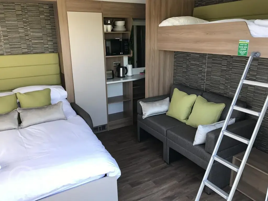 Family Studio Pod Cabins interior with family beds and kitchenette