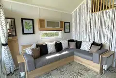 Hill top lodge interior with a double sofa bed, kitchen and mezzanine bedroom