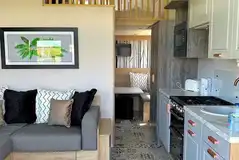 Hill top lodge interior with a double sofa bed, kitchen and mezzanine bedroom