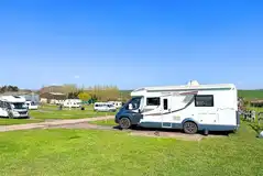 Electric hardstanding and grass pitches at Higher Moor Farm Campsite