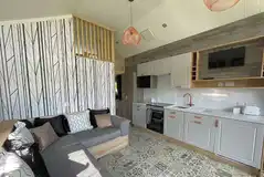 Hill top lodge interior with a double sofa bed, kitchen and mezzanine bedroom