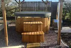 Plus Deluxe Lotus Belle Tent with round hot tub under gazebo