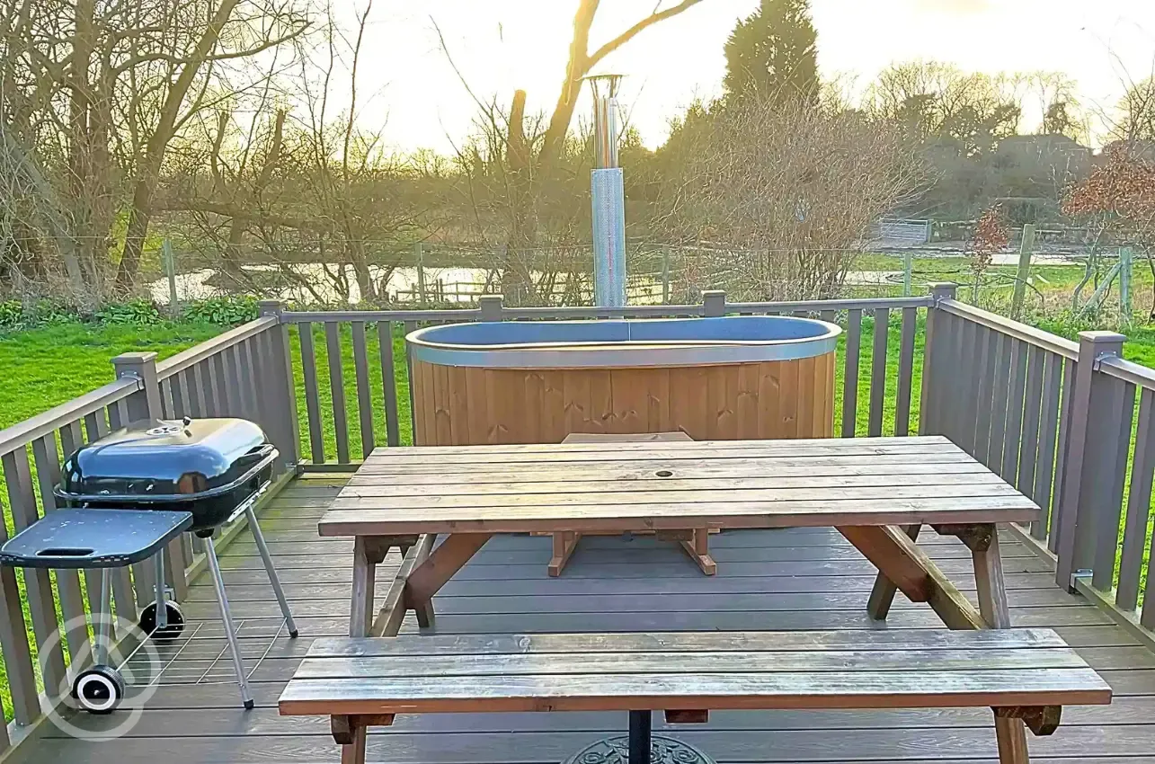 Glamping pod hot tubs, seating and BBQ
