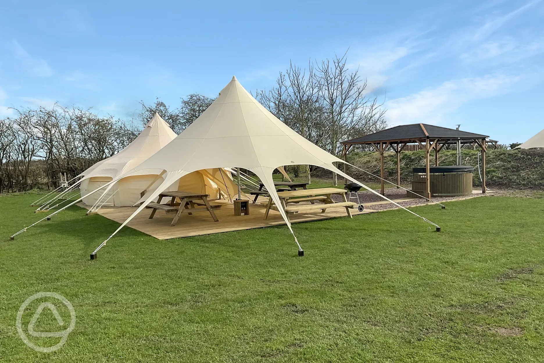 Plus Deluxe Lotus Belle Tent with round hot tub and undercover outdoor seating