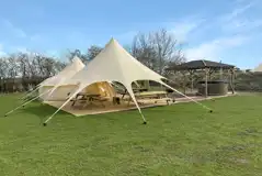 Plus Deluxe Lotus Belle Tent with round hot tub and undercover outdoor seating