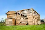 Just For Ewe shepherd's hut with a covered outdoor area and hot tub