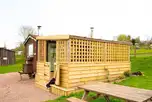 The Old Ram's shepherd's hut with a covered outdoor area and hot tub