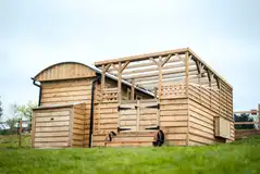 Just For Ewe shepherd's hut with a covered outdoor area and hot tub