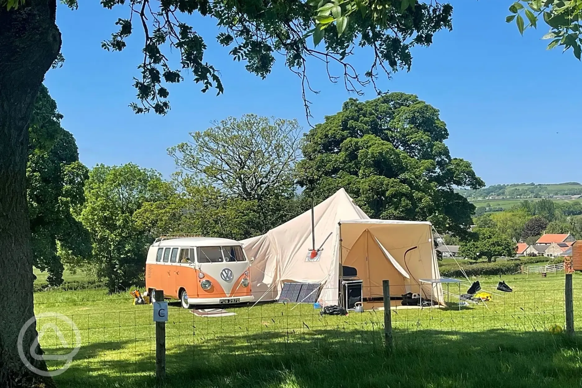 Non electric grass pitches with a campervan and bell tent awning