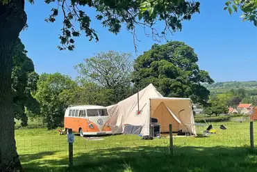 Non electric grass pitches with a campervan and bell tent awning