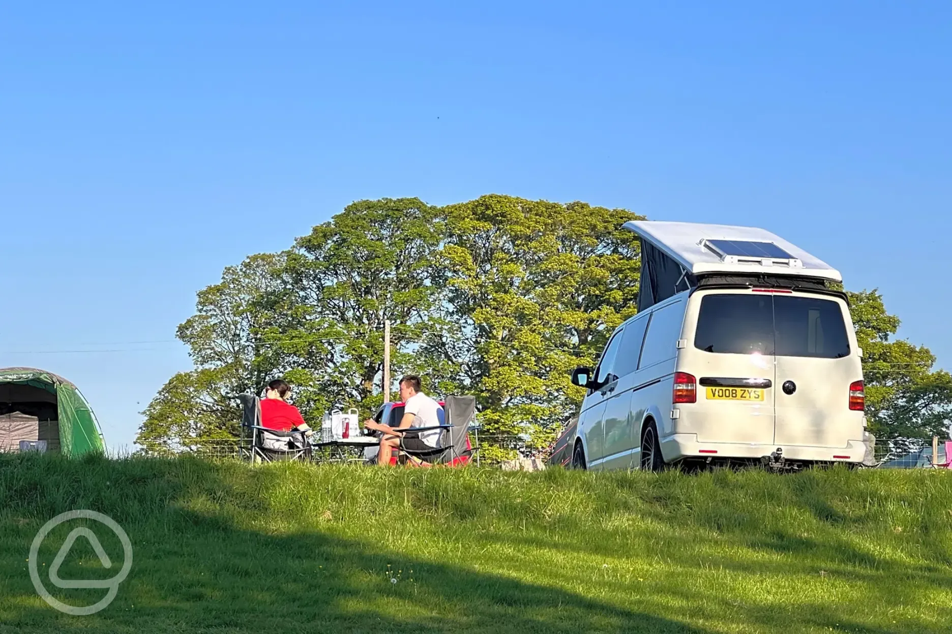 Electric grass pitches with campervans welcome