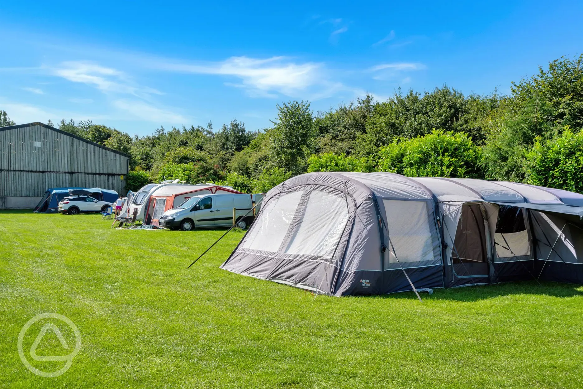 Electric grass pitches (family friendly) with a large tent