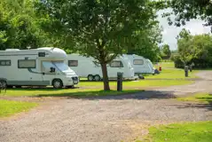 Fully serviced touring pitches surrounded by trees at Lady Heyes Holiday Park