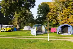 Large tents and a VW campervan on the pitches at Laleham Camping Club