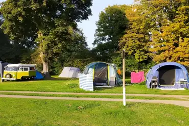 Large tents and a VW campervan on the pitches at Laleham Camping Club