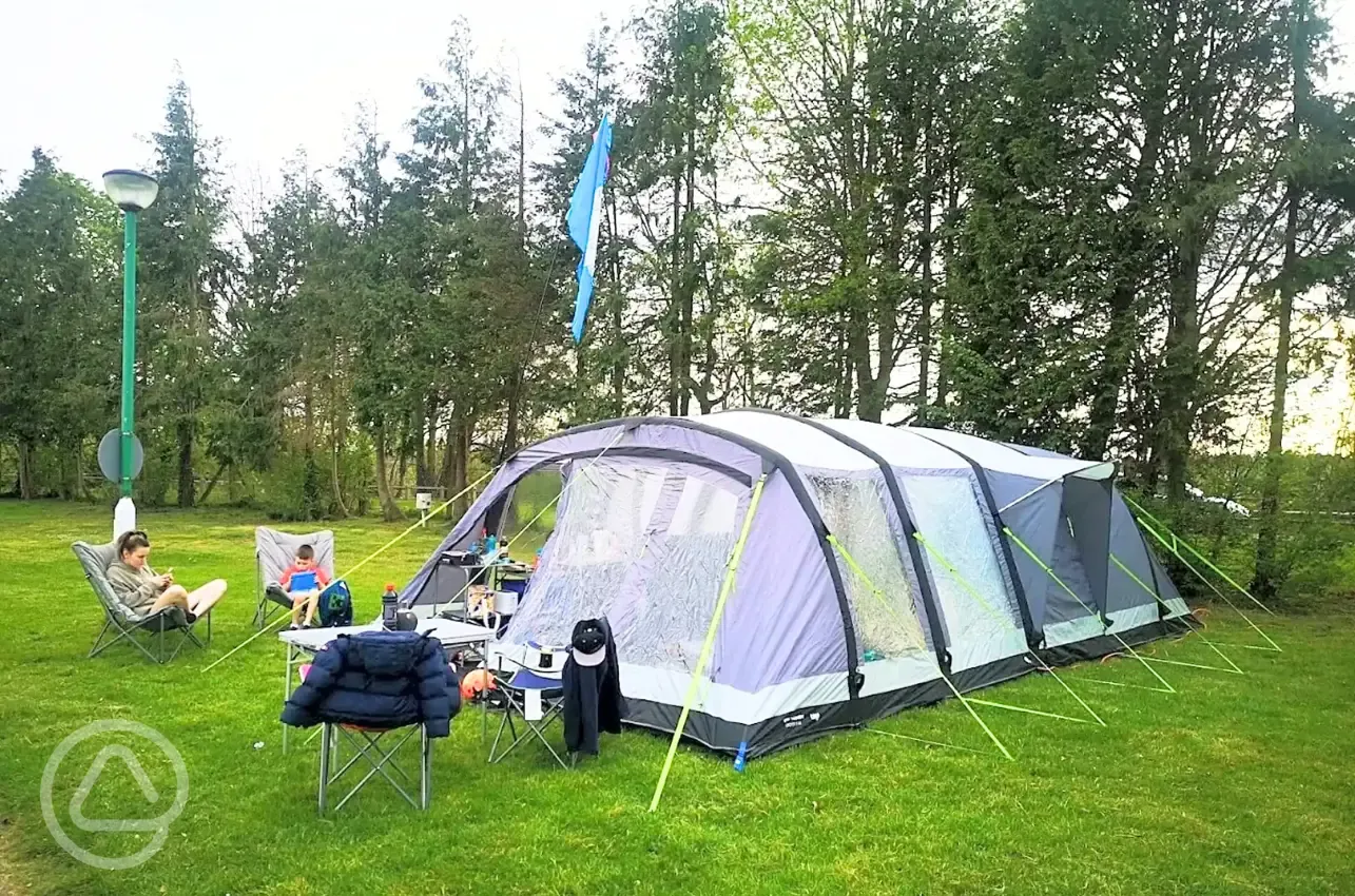 Large tent on a grass pitch at Laleham Camping Club