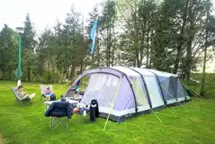 Large tent on a grass pitch at Laleham Camping Club