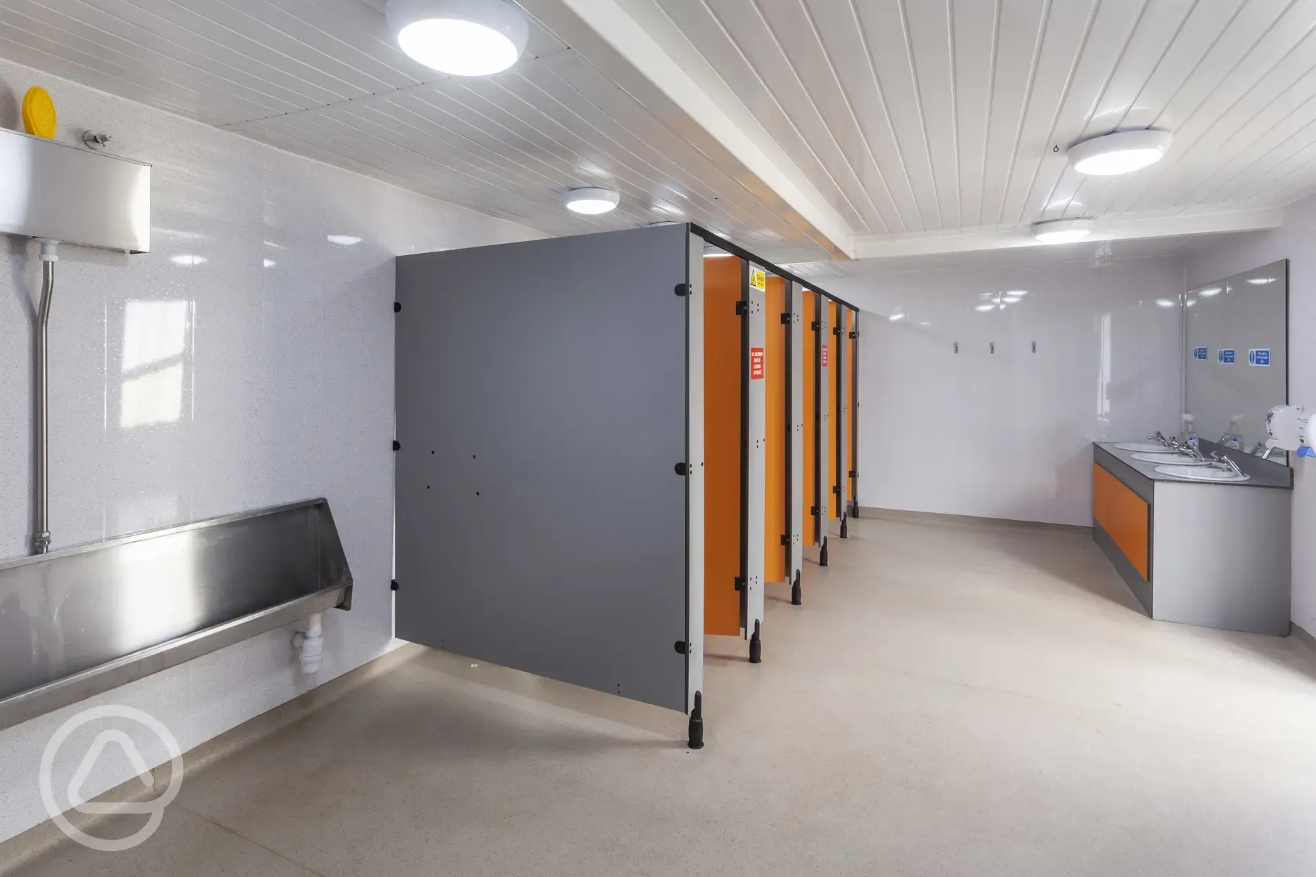 Toilets with cubicles, sinks and mirrors