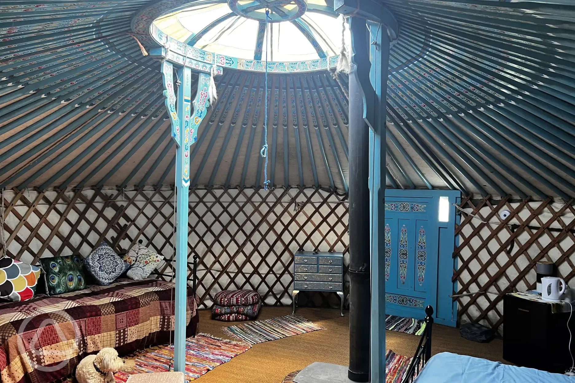 Yurt interior with double bed and two single beds