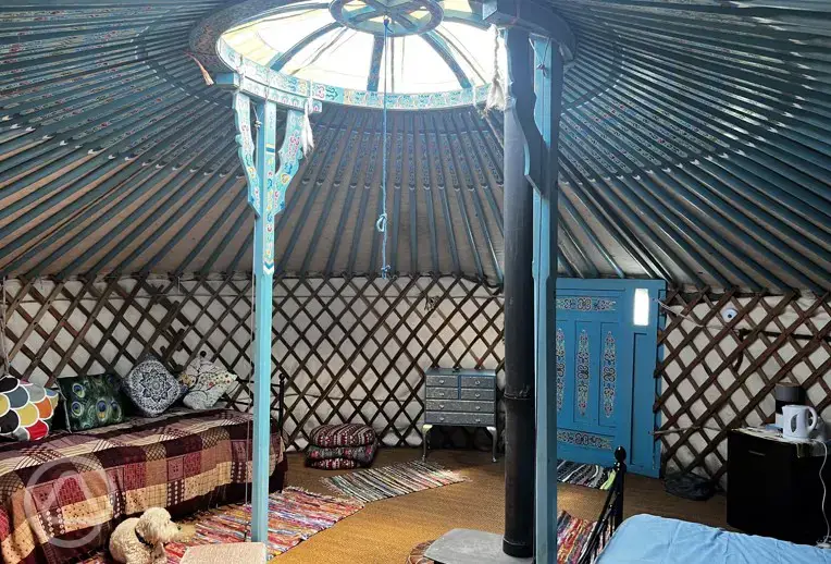 Yurt interior with double bed and two single beds