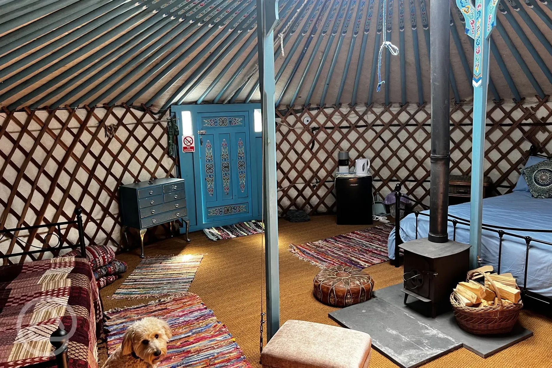 Yurt interior, fully furnished with a wood burner