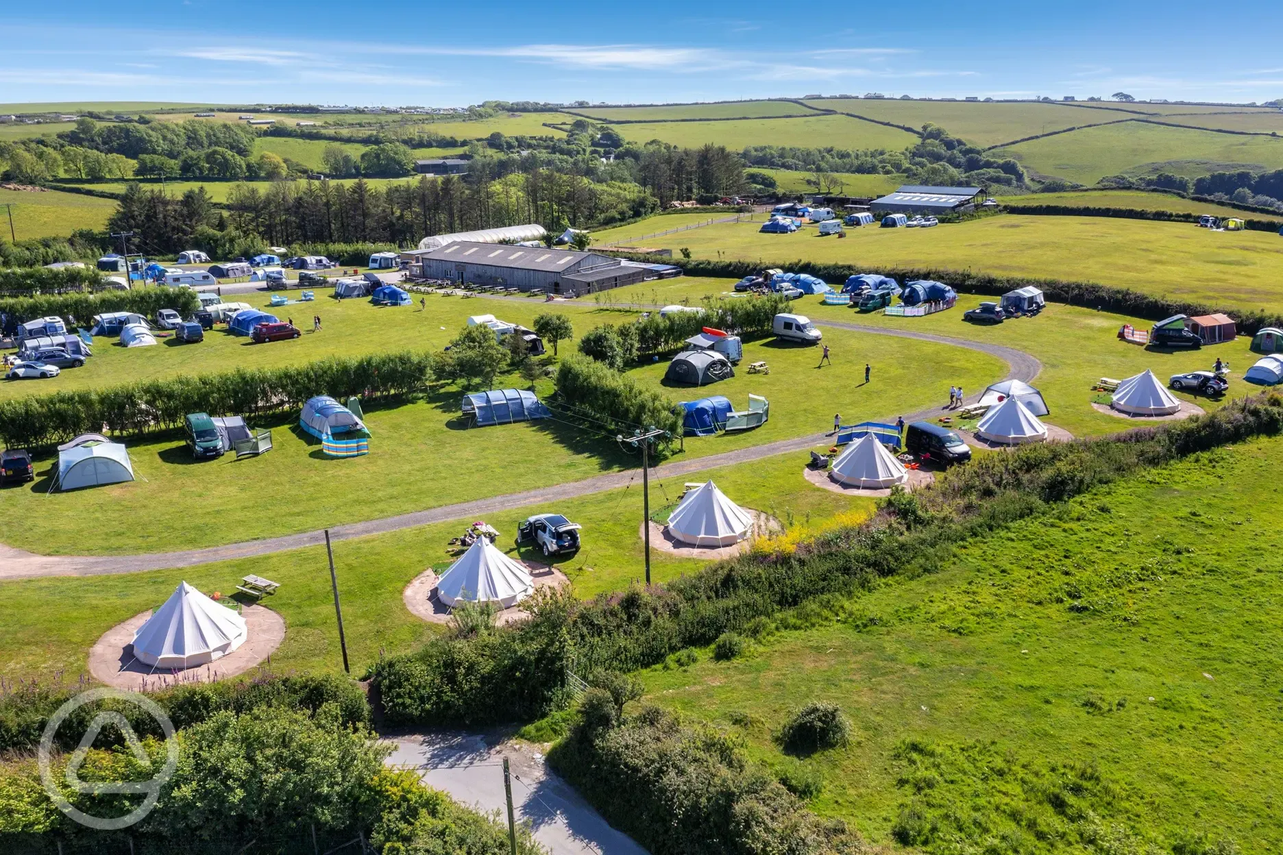 Aerial view of the grass pitches and bell tents