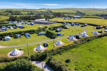 Aerial view of the grass pitches and bell tents