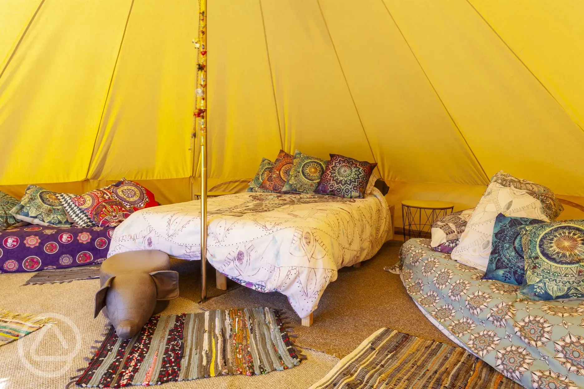 Bell tent interior with cosy furnishings
