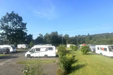 Electric hardstanding pitches with a grass area 