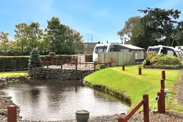 Pond view hardstanding pitches at Lidalia Caravan Park