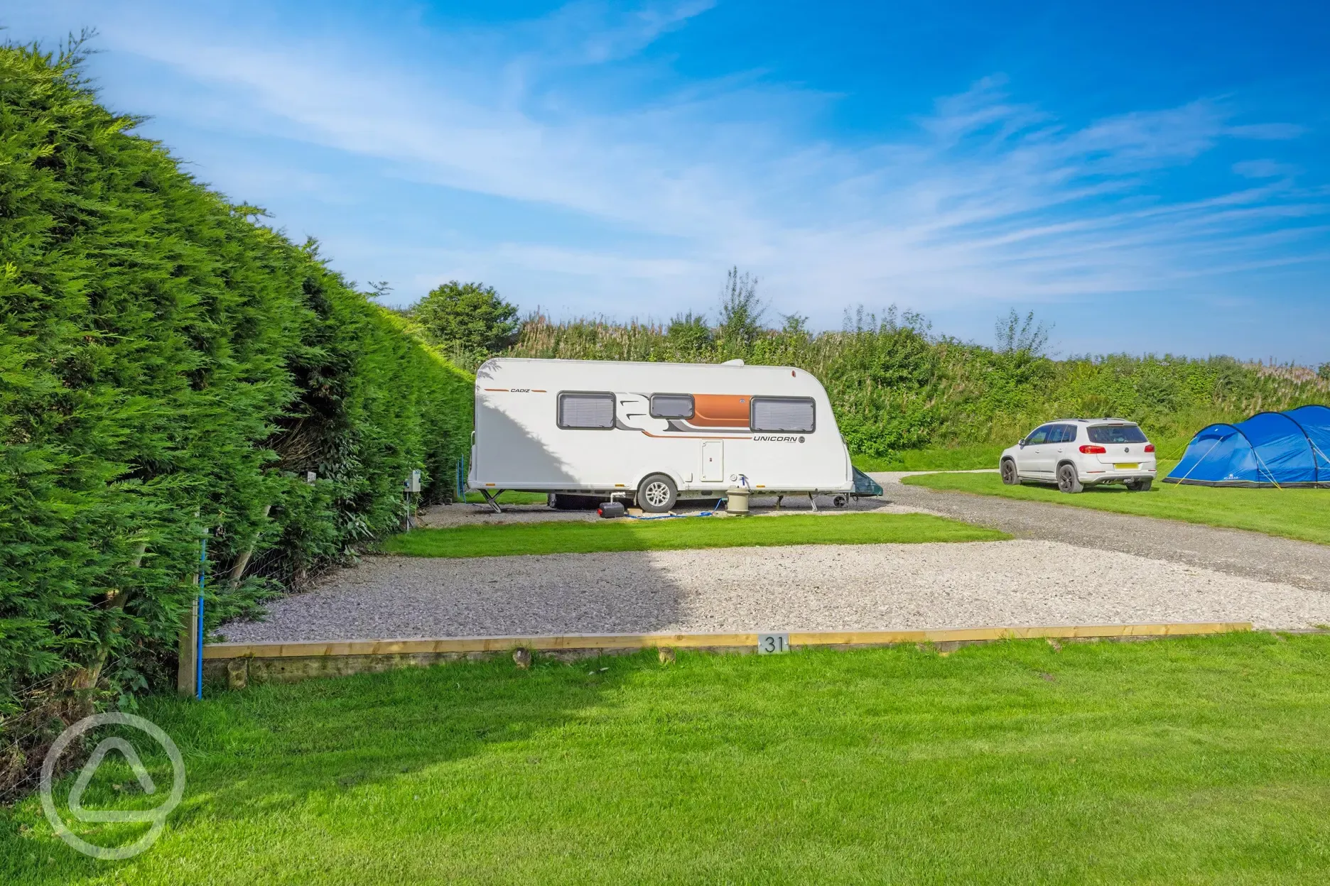 Electric hardstanding touring pitches with grass areas between