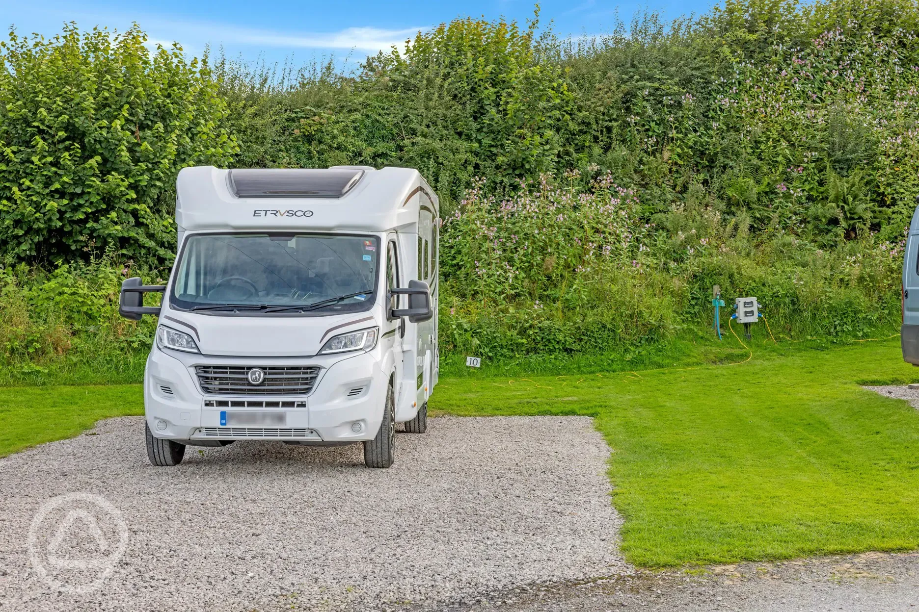 Electric hardstanding touring pitches with grass areas between