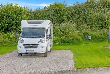 Electric hardstanding touring pitches with grass areas between