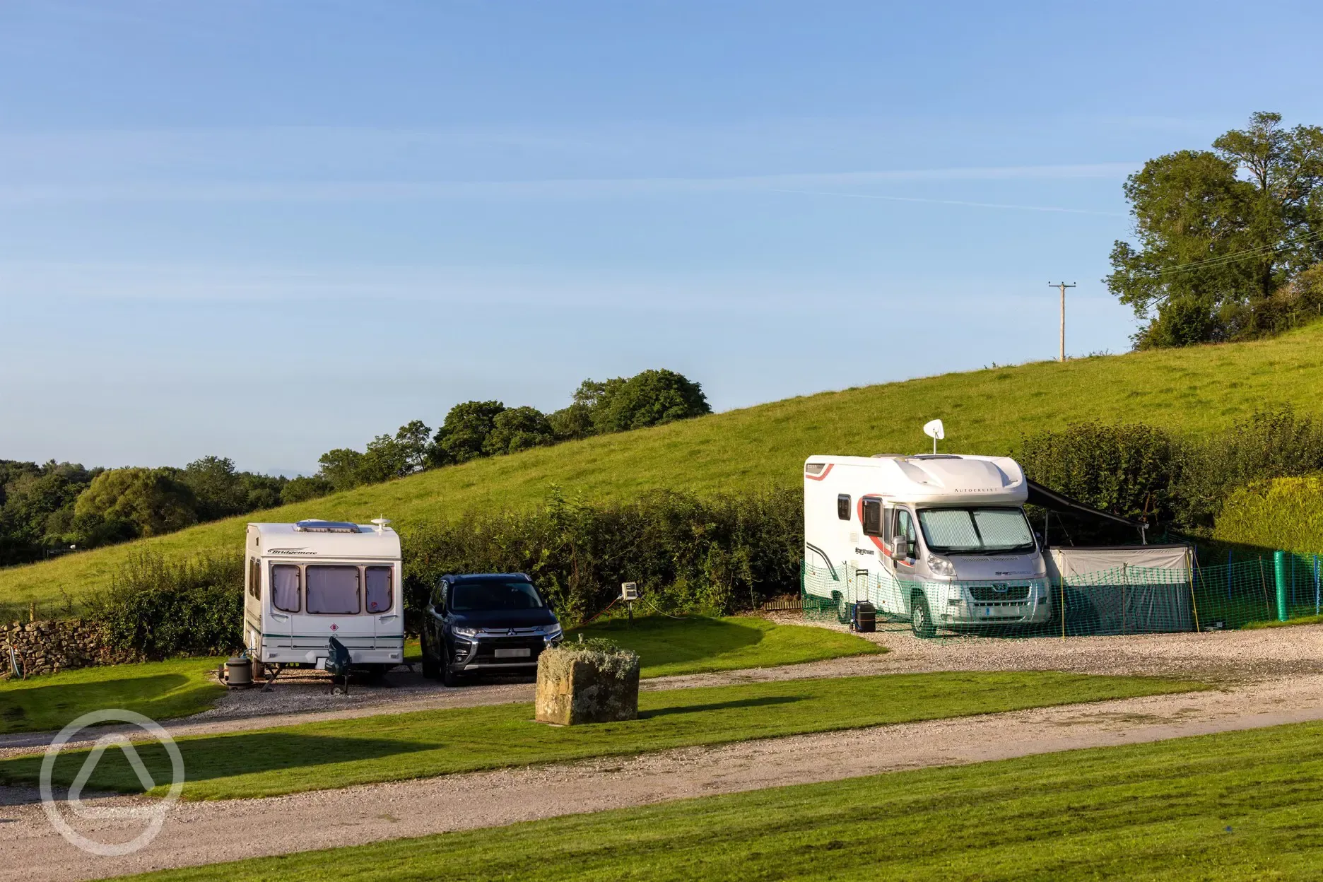 Electric hardstanding touring pitches with grass areas between