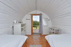 Poppy camping pod interior with a kettle and small dining area Poppy camping pod interior with a kettle and small dining area