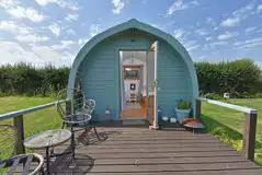 Poppy camping pod with an outdoor deck and seating Poppy camping pod with an outdoor deck and seating