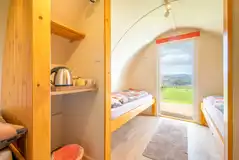 Camping pod interior with four single beds and a kettle Camping pod interior with four single beds and a kettle