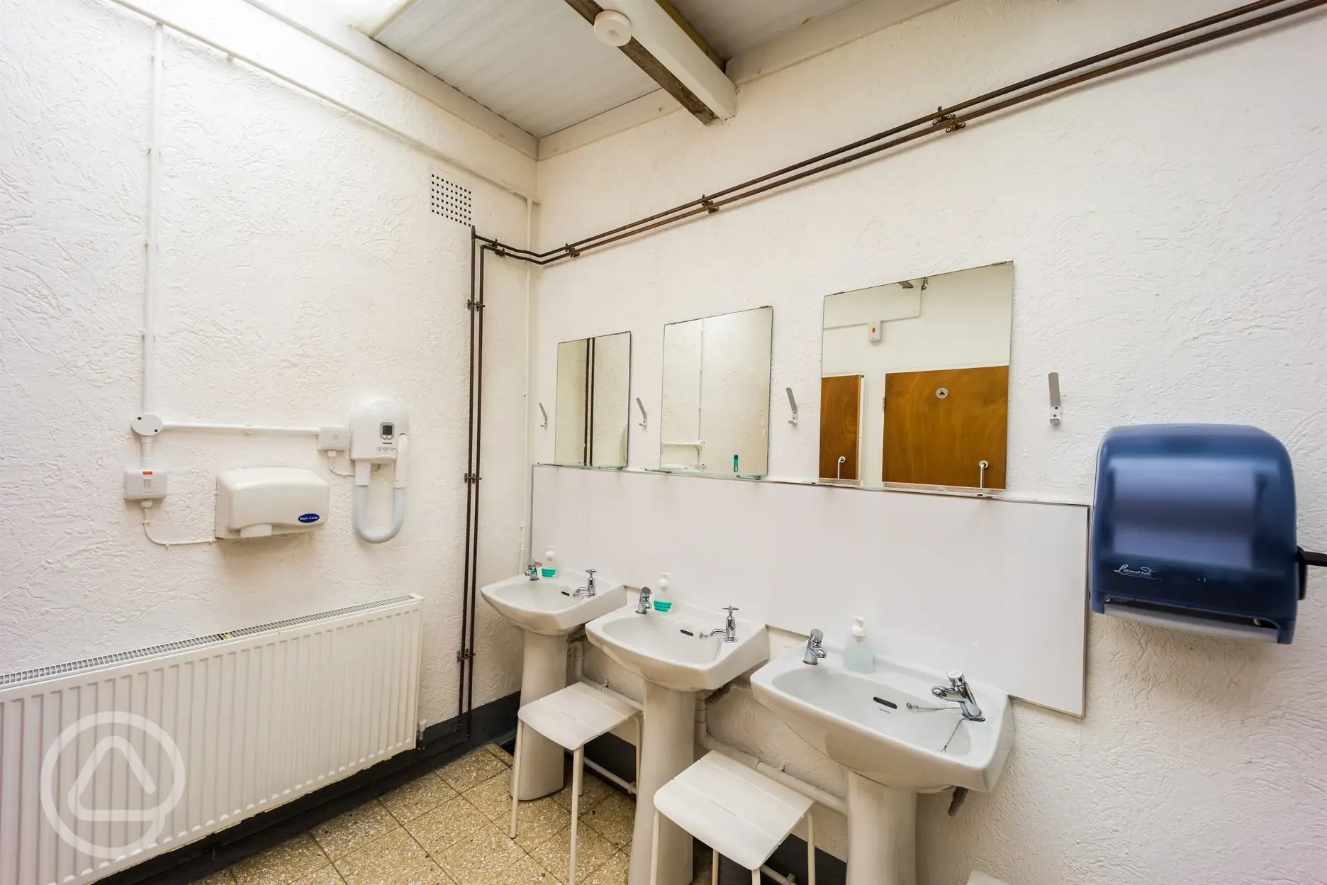 Sinks, hand dryers, and a hairdryer in the toilet blocks