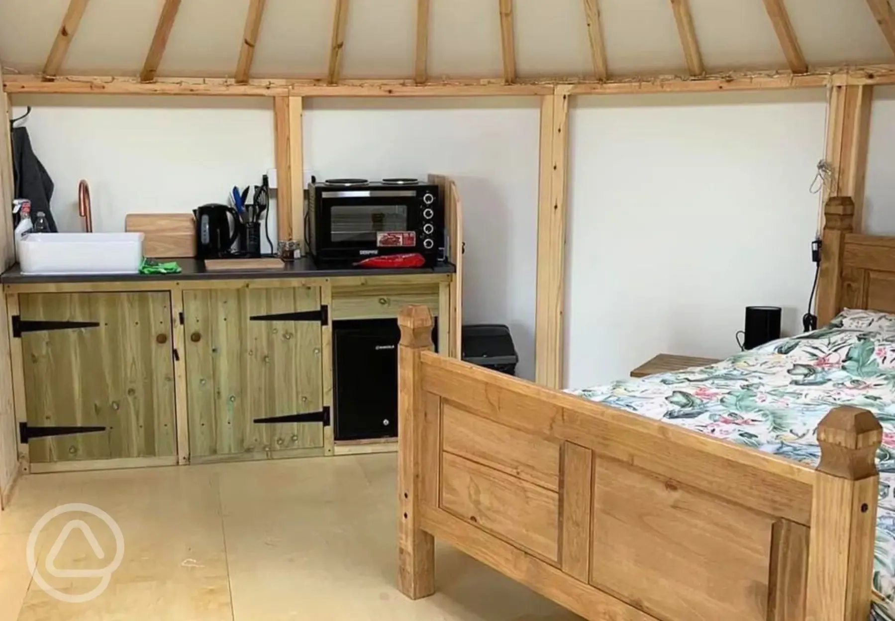 Roundhouse interior with a double bed and kitchenette Roundhouse interior with a double bed and kitchenette