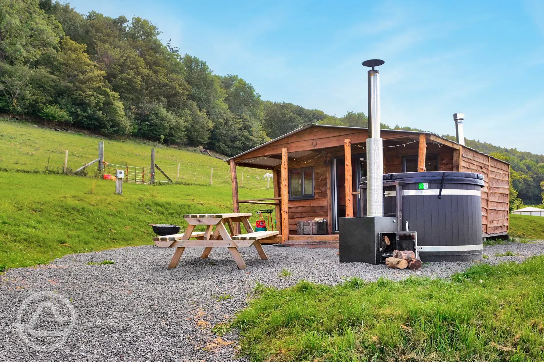 Caradoc Lodge with a wood-fired hot tub and picnic bench