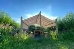 Communal outdoor seating area for the bell tent field