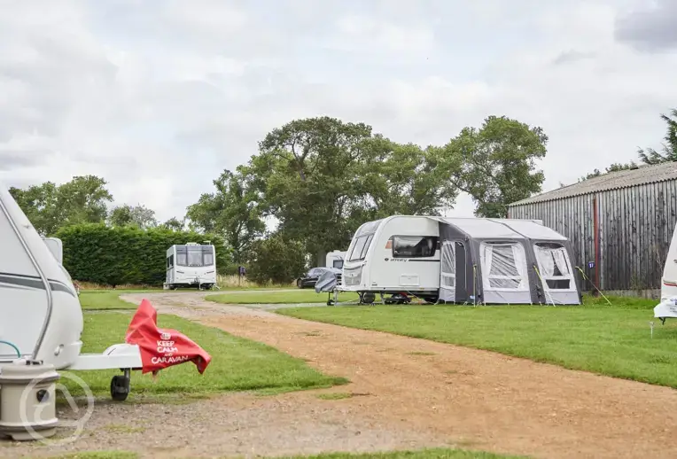 Field barn hardstanding pitches with optional electric at Monks Barn Farm