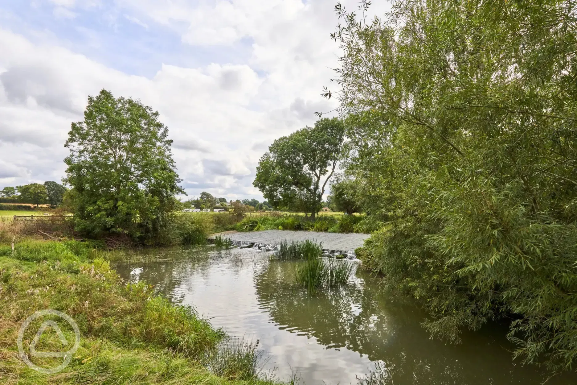 Lower meadow pitches beside the nearby River Stour Lower meadow pitches beside the nearby River Stour