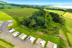 Aerial of the fully serviced hardstanding touring pitches with elevated views
